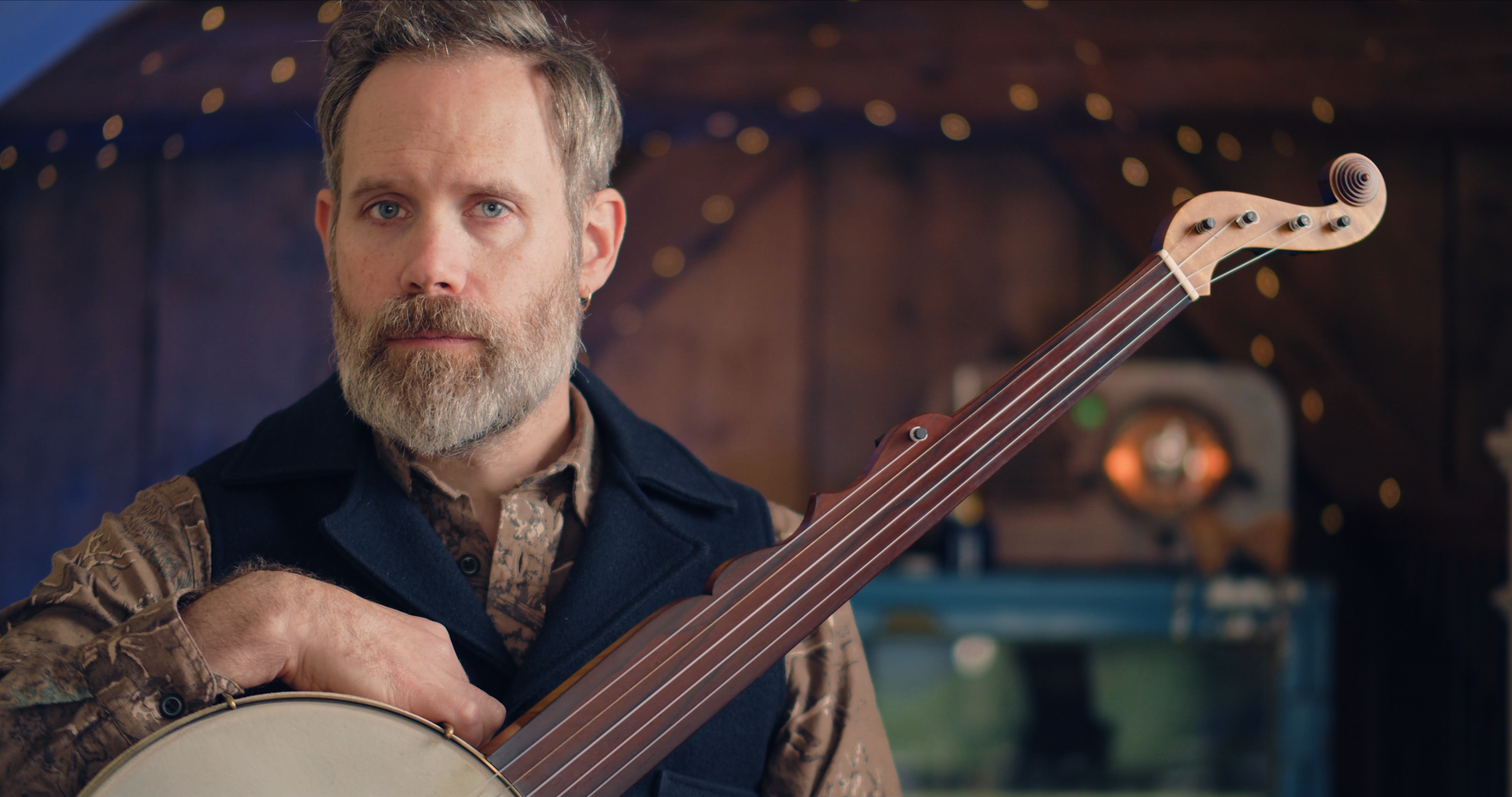 Tom Collins holding a clawhammer banjo